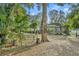 Relaxing backyard with a metal swing bench, lush greenery, and a tranquil atmosphere at 214 Forest Park Ln, Lady Lake, FL 32159