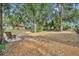 Spacious backyard with mature trees and seating area at 214 Forest Park Ln, Lady Lake, FL 32159