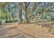 Large backyard with mature trees and a house in the distance at 214 Forest Park Ln, Lady Lake, FL 32159