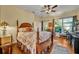 Charming bedroom with a wooden bed frame and access to a private patio at 214 Forest Park Ln, Lady Lake, FL 32159