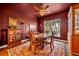 Elegant dining room features dark walls, hardwood floors, and a large window at 214 Forest Park Ln, Lady Lake, FL 32159