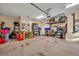 Organized garage with overhead storage and workbench at 214 Forest Park Ln, Lady Lake, FL 32159