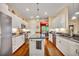 Modern kitchen with white cabinets, granite countertops, and stainless steel appliances at 214 Forest Park Ln, Lady Lake, FL 32159