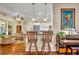 Modern kitchen with white cabinets, breakfast bar, and stainless steel appliances at 214 Forest Park Ln, Lady Lake, FL 32159