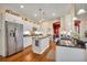 Modern kitchen with white cabinets, granite countertops, and stainless steel appliances at 214 Forest Park Ln, Lady Lake, FL 32159