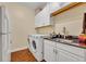 Laundry room with washer, dryer, cabinets and granite countertop at 214 Forest Park Ln, Lady Lake, FL 32159