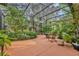 Relaxing screened patio with various plants and seating at 214 Forest Park Ln, Lady Lake, FL 32159