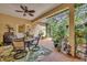 Bright sunroom with patio furniture and lush greenery at 214 Forest Park Ln, Lady Lake, FL 32159