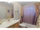 Guest bathroom with tub shower combo, and wood vanity at 2240 Avon Loop, The Villages, FL 32162