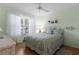 Bedroom with a double bed, ceiling fan, and wood floors at 2240 Avon Loop, The Villages, FL 32162