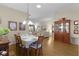 Bright dining room with hardwood floors and wood hutch at 2240 Avon Loop, The Villages, FL 32162