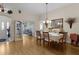 Dining room with hardwood floors, table set for six at 2240 Avon Loop, The Villages, FL 32162