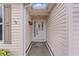 Front entry with white door and star-shaped floor tile at 2240 Avon Loop, The Villages, FL 32162