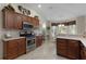 Kitchen features stainless steel appliances and ample cabinetry at 2240 Avon Loop, The Villages, FL 32162