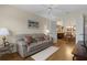 Living room with a couch, view into dining area, and hardwood floors at 2240 Avon Loop, The Villages, FL 32162