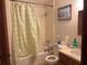 Bathroom with shower/tub combo and patterned curtain at 225 N West St, Bushnell, FL 33513