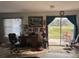 Living room with desk, view of backyard and sliding doors at 225 N West St, Bushnell, FL 33513