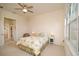 Bright bedroom with floral bedding and large window at 2298 Caledonian St, Clermont, FL 34711