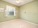 Well-lit bedroom with carpet flooring and window shutters at 2298 Caledonian St, Clermont, FL 34711