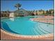 Resort-style pool with a large deck and surrounding landscaping at 2298 Caledonian St, Clermont, FL 34711