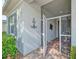 Inviting front porch entry with a screened-in area and brick flooring at 2298 Caledonian St, Clermont, FL 34711