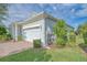 Exterior view of the garage with a brick driveway at 2298 Caledonian St, Clermont, FL 34711