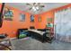 Fun bedroom with orange walls, ceiling fan, and built-in shelving at 2334 Bexley Dr, Tavares, FL 32778