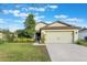 Charming one-story house with light green exterior, attached garage, and well-manicured lawn at 2334 Bexley Dr, Tavares, FL 32778