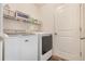 Convenient laundry room with washer, dryer, and shelving at 2334 Bexley Dr, Tavares, FL 32778