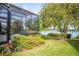 Landscaped backyard with lake view and lush foliage at 2441 Bar Harbor Bay, Mount Dora, FL 32757