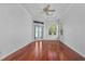 Bedroom with hardwood floors, water view, and access to patio at 2441 Bar Harbor Bay, Mount Dora, FL 32757