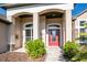 Inviting entryway with a red door and brick walkway at 2441 Bar Harbor Bay, Mount Dora, FL 32757