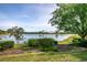 Scenic backyard oasis with lush landscaping and tranquil lake view at 2441 Bar Harbor Bay, Mount Dora, FL 32757