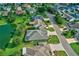 House with a gray roof and a green lawn next to a pond at 2532 Edenville Path, The Villages, FL 32162