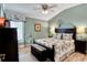 Bedroom with king-size bed, nightstands and decorative wall art at 2532 Edenville Path, The Villages, FL 32162