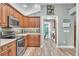 Kitchen with stainless steel appliances and wood cabinets at 2532 Edenville Path, The Villages, FL 32162