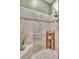 Walk-in shower with built-in seat and grab bar at 2532 Edenville Path, The Villages, FL 32162