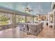 Relaxing sunroom with wicker furniture, lake view, and light blue ceiling at 2532 Edenville Path, The Villages, FL 32162