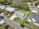 Aerial shot of property showcasing landscaping, roof, driveway, and neighborhood at 25941 Newcombe Cir, Leesburg, FL 34748