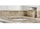 Close up of bathroom countertop with granite counters, white cabinets and a modern faucet at 25941 Newcombe Cir, Leesburg, FL 34748