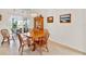 Dining room features a wood table and chairs with a cabinet for storage and decor at 25941 Newcombe Cir, Leesburg, FL 34748