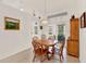 Bright dining room with wood table, chair set, tile floors, and access to the lanai at 25941 Newcombe Cir, Leesburg, FL 34748