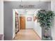 Gallery entrance featuring a decorative plant, artwork, and a welcoming doorway into the exhibit space at 25941 Newcombe Cir, Leesburg, FL 34748