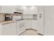 A kitchen featuring white cabinets and appliances at 25941 Newcombe Cir, Leesburg, FL 34748