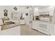 Well-lit kitchen with white cabinetry, granite countertops, and stainless steel appliances at 25941 Newcombe Cir, Leesburg, FL 34748