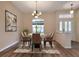 Formal dining room with chandelier and hardwood floors at 26908 Honeymoon Ave, Leesburg, FL 34748