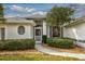 Front entrance with walkway, landscaping, and white exterior at 26908 Honeymoon Ave, Leesburg, FL 34748