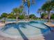 Community pool with surrounding palm trees and landscaping at 26908 Honeymoon Ave, Leesburg, FL 34748