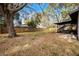 Backyard view with large tree and screened porch at 2725 Lakewood Ln, Eustis, FL 32726