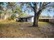 Large backyard with mature trees and wooden fence at 2725 Lakewood Ln, Eustis, FL 32726